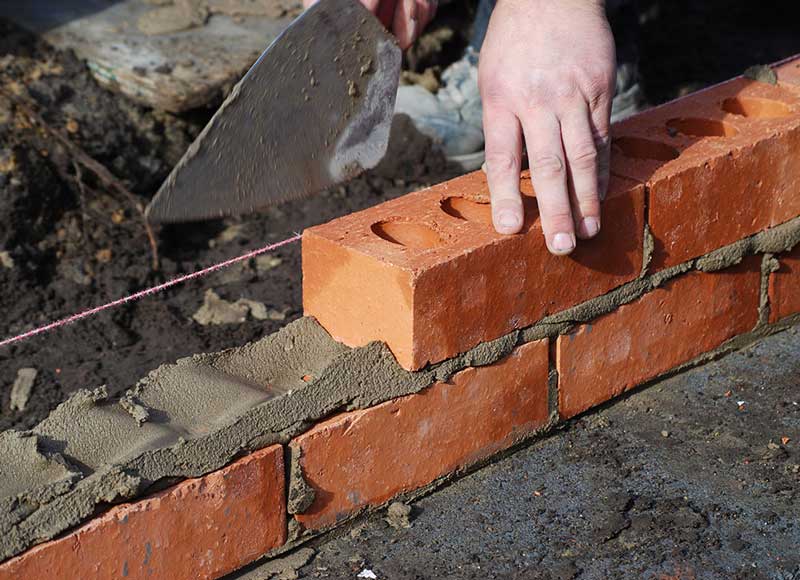 Installing bricks with mortar
